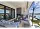 Relax on the outdoor patio with grill, fireplace, comfortable seating, and waterfront views at 7974 1St S Ave, St Petersburg, FL 33707