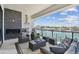 Inviting outdoor patio with a built-in grill, fireplace, comfortable seating, and scenic waterfront views at 7974 1St S Ave, St Petersburg, FL 33707