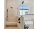 Walk-in shower with stone tile surround and modern fixtures at 7974 1St S Ave, St Petersburg, FL 33707
