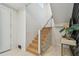 Bright staircase featuring modern railings and accent wall, creating an elegant transition between floors at 7974 1St S Ave, St Petersburg, FL 33707