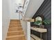 View of stairs featuring wood steps, metal cable railing, and gray accent wall at 7974 1St S Ave, St Petersburg, FL 33707