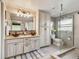Modern bathroom boasting double sinks, glass shower, and ample cabinet space at 854 Harbor Is, Clearwater, FL 33767