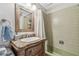 Bathroom featuring a unique vanity, framed mirror, and tiled walls at 854 Harbor Is, Clearwater, FL 33767