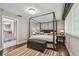 Charming bedroom featuring a four-poster bed, hardwood floors, and ensuite bathroom, creating a relaxing retreat at 854 Harbor Is, Clearwater, FL 33767