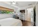 Well-lit bedroom with desk area, mounted TV, and exterior view through the window at 854 Harbor Is, Clearwater, FL 33767