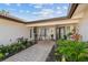 Charming front porch with rocking chairs, brick pavers, and a 'Welcome' sign, creating a cozy and inviting entrance at 854 Harbor Is, Clearwater, FL 33767