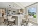 Bright kitchen with white quartz countertops, stainless steel appliances, and bar seating overlooking a serene water view at 854 Harbor Is, Clearwater, FL 33767