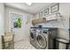 Laundry room with a front-load washer/dryer and ample shelving at 854 Harbor Is, Clearwater, FL 33767