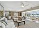 Spacious living room with tile floors and open layout, featuring comfortable seating and serene water views at 854 Harbor Is, Clearwater, FL 33767