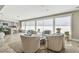 Open-concept living space with neutral decor, large windows, and a serene sitting area with ample natural light at 854 Harbor Is, Clearwater, FL 33767