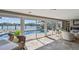 Living room featuring large windows with water and pool views, modern decor, and an open, airy layout at 854 Harbor Is, Clearwater, FL 33767