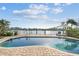 Inviting pool area with comfortable lounge chairs and an umbrella, offering a perfect spot for relaxation and waterfront views at 854 Harbor Is, Clearwater, FL 33767