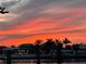 Sunset over waterfront community with palm trees and boat docks at 854 Harbor Is, Clearwater, FL 33767