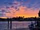 Vibrant sunset over waterfront, captured from the patio with furniture at 854 Harbor Is, Clearwater, FL 33767