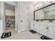 Modern bathroom with double vanity, large mirror, and walk-in closet at 8960 Windlass Cv, Parrish, FL 34219