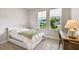 Bright bedroom with large windows, a cozy bed, and a desk for a comfortable living space at 8960 Windlass Cv, Parrish, FL 34219