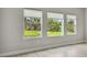 Bright room with large windows overlooking greenery at 8960 Windlass Cv, Parrish, FL 34219