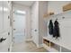 Organized mudroom featuring built-in storage with hooks, shelves, and a bench for convenience at 8960 Windlass Cv, Parrish, FL 34219
