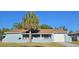 Inviting single-story home with a cozy front porch, perfect for relaxing outdoors at 1007 Greenleaf Way, Tarpon Springs, FL 34689