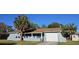 Charming single-story home featuring an attached garage and welcoming front porch at 1007 Greenleaf Way, Tarpon Springs, FL 34689