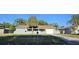 Attractive single-story home enhanced by tropical landscaping and a well-maintained lawn at 1007 Greenleaf Way, Tarpon Springs, FL 34689