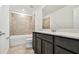 Modern bathroom featuring a shower-tub combo with tile surround, vanity with sink, and modern fixtures at 10520 Hidden Banks Gln, Parrish, FL 34219