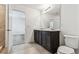 Spacious bathroom with double sink vanity, tile flooring, and view into adjacent bedroom area at 10520 Hidden Banks Gln, Parrish, FL 34219