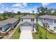 New construction home featuring a two-car garage, neutral paint, simple landscaping, and close proximity to golf course at 10520 Hidden Banks Gln, Parrish, FL 34219