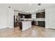 Modern kitchen featuring stainless steel appliances, dark cabinetry, and a bright white kitchen island at 10520 Hidden Banks Gln, Parrish, FL 34219
