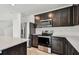 Well-equipped kitchen with stainless steel appliances and dark wood cabinets at 10520 Hidden Banks Gln, Parrish, FL 34219