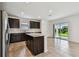 Open kitchen with a center island, stainless appliances, and access to the patio at 10520 Hidden Banks Gln, Parrish, FL 34219
