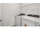 Efficient laundry area with modern washer and dryer, and storage shelves at 10520 Hidden Banks Gln, Parrish, FL 34219