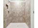 Modern tiled shower with built-in niche and updated fixtures at 10520 Hidden Banks Gln, Parrish, FL 34219