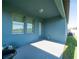 Covered back porch offers a relaxing outdoor space with windows and access to the backyard at 10628 Bahama Woodstar Ct, Riverview, FL 33579
