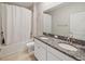 Well-lit bathroom featuring a double sink vanity with granite countertop and a shower/tub combo at 10628 Bahama Woodstar Ct, Riverview, FL 33579