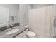 Bathroom featuring a granite countertop, white cabinets, and a shower with a neutral curtain at 10628 Bahama Woodstar Ct, Riverview, FL 33579