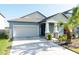 Charming single-Gathering home with a two-car garage, stone accents, and a well-manicured lawn at 10628 Bahama Woodstar Ct, Riverview, FL 33579