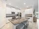 Spacious kitchen with white cabinetry, granite countertops, stainless steel appliances and a large center island at 10628 Bahama Woodstar Ct, Riverview, FL 33579