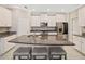 Spacious kitchen featuring white cabinets, stainless steel appliances, and a large center island at 10628 Bahama Woodstar Ct, Riverview, FL 33579