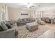 Inviting living room with coordinated gray furniture, stylish rug, and view into dining area at 10628 Bahama Woodstar Ct, Riverview, FL 33579