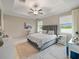 Spacious main bedroom featuring a tray ceiling, neutral colors, two windows and marble tile flooring at 10628 Bahama Woodstar Ct, Riverview, FL 33579