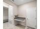 Office showcasing a custom granite desktop, neutral walls, and tiled floors at 10628 Bahama Woodstar Ct, Riverview, FL 33579