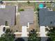 Aerial view of a two-story house with fenced backyard and nearby homes at 11136 Hartford Fern Dr, Riverview, FL 33569