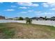 The spacious backyard features a white fence and small palm tree at 11136 Hartford Fern Dr, Riverview, FL 33569