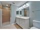 Bathroom with a glass shower and a single sink vanity with large mirror at 11136 Hartford Fern Dr, Riverview, FL 33569