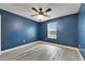 Empty bedroom featuring a ceiling fan, light gray wood floors, and a window at 11136 Hartford Fern Dr, Riverview, FL 33569