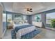 Beautiful bedroom featuring a tray ceiling, coastal decor, and stylish blue accents throughout at 11136 Hartford Fern Dr, Riverview, FL 33569
