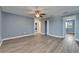Bedroom with gray wood flooring, blue walls, and doors leading to other rooms at 11136 Hartford Fern Dr, Riverview, FL 33569