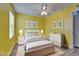 This staged bedroom offers a comfortable bed, lamps, and artwork at 11136 Hartford Fern Dr, Riverview, FL 33569