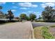 A paved entrance to the community with well-maintained landscaping, gate, and street lamp at 11136 Hartford Fern Dr, Riverview, FL 33569